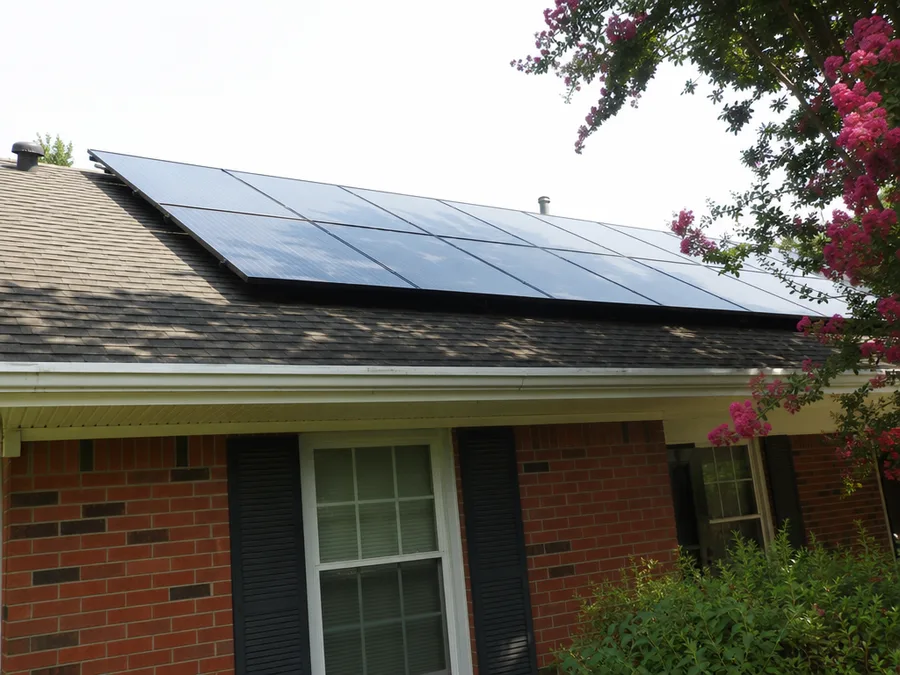 Solar modules on a low pitch shingle roof seen from the front yard